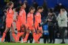 Barcelona's Aitana Bonmati, right, and her teammates leave the pitch at the the end of the women's Champions League opening phase soccer match between Chelsea FC and FC Barcelona, in London, Thursday, Nov. 20, 2025. (AP Photo/Kin Cheung)