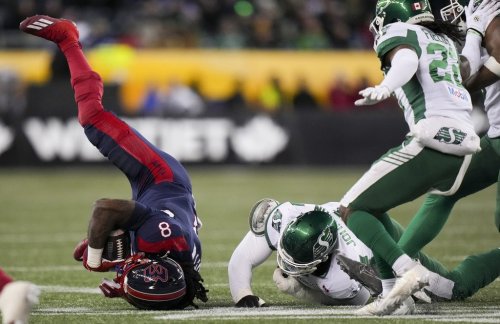 Montreal Alouettes' Stevie Scott III (8) is upended by Saskatchewan Roughriders' Micah Johnson (4) during first half CFL football action at the 112th Grey Cup, in Winnipeg on Sunday, Nov. 16, 2025. THE CANADIAN PRESS/Darryl Dyck