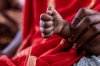 A mother holds the clenched hand of her daughter, who has not unclenched it in the eight months since fleeing mercenaries in Mali and finding refuge in Douankara, Mauritania, Saturday, Nov. 8, 2025. (AP Photo/Caitlin Kelly)