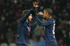 PSG's Bradley Barcola, right, celebrates with teammate Khvicha Kvaratskhelia after scoring his side's third goal during the French League One soccer match between Paris Saint Germain and Le Havre in Paris, France, Saturday, Nov. 22, 2025. (AP Photo/Aurelien Morissard)