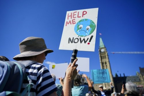People participate in a climate protest on Parliament Hill in Ottawa on Friday, Sept. 15, 2023. THE CANADIAN PRESS/Sean Kilpatrick