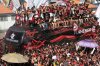 Flamengo soccer fans see their team off as it arrives to the airport ahead of the Copa Libertadores final, in Rio de Janeiro, Wednesday, Nov. 26, 2025. (AP Photo/Bruna Prado)