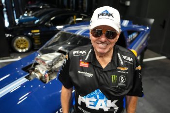 FILE - Drag racing car owner John Force poses next to his original funny car, Aug. 28, 2025, in Zionsville, Ind. (AP Photo/Michael Conroy, File)