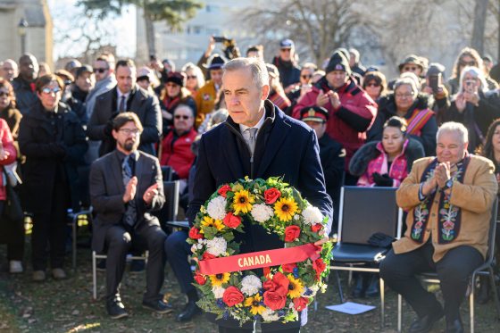 Prime Minister Mark Carney lays a wreath at Louis Riel's grave to commemorate the 145th anniversary of Riel's execution at the St. Boniface Cathedral cemetery on Sunday morning. (Mike Sudoma/Free Press)