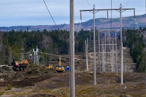 FILE - Heavy machinery is used to clear an existing Central Maine Power electricity corridor that has been widened to make way for new utility poles, April 26, 2021, near Bingham, Maine. (AP Photo/Robert F. Bukaty, File)