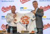 Baltimore Orioles general manager Mike Elias, right, presents the baseball club's new manager Craig Albernaz with his team jersey after introducing him during a news conference, Tuesday, Nov. 4, 2025, in Baltimore. (Jerry Jackson/The Baltimore Banner via AP)