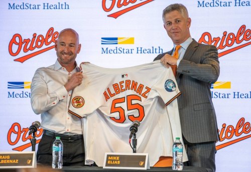 Baltimore Orioles general manager Mike Elias, right, presents the baseball club's new manager Craig Albernaz with his team jersey after introducing him during a news conference, Tuesday, Nov. 4, 2025, in Baltimore. (Jerry Jackson/The Baltimore Banner via AP)