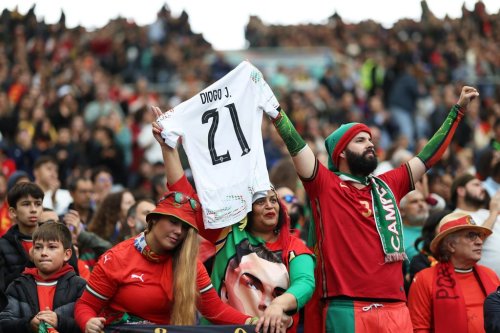 Portugal supporters hold a shirt with the number of late Portuguese player Diogo Jota during a World Cup 2026 group F qualifying soccer match between Portugal and Armenia in Porto, Portugal, Sunday, Nov. 16, 2025. (AP Photo/Luis Vieira)