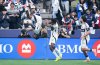 Vancouver Whitecaps' Emmanuel Sabbi, left, flips as he celebrates his goal with Ali Ahmed, centre, and Brian White during the first half of the MLS Western Conference semifinal playoff soccer match against Los Angeles FC, in Vancouver, on Saturday, November 22, 2025. THE CANADIAN PRESS/Darryl Dyck