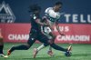 Vancouver FC's Kunle Dada-Luke, left, and Vancouver Whitecaps' Ali Ahmed (22) vie for the ball during the first half of the Canadian Championship final soccer match, in Vancouver, on Wednesday, October 1, 2025. THE CANADIAN PRESS/Ethan Cairns
