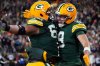 Green Bay Packers wide receiver Christian Watson (9) celebrates with guard Aaron Banks (65) after scoring a touchdown against the Chicago Bears during the second half of an NFL football game Sunday, Dec. 7, 2025, in Green Bay, Wis. (AP Photo/Morry Gash)