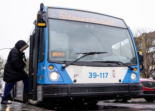 People board a Montreal transit agency bus in Montreal on Friday, Nov. 14, 2025. THE CANADIAN PRESS/Christopher Katsarov