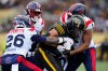 Hamilton Tiger-Cats wide receiver Kiondre Smith (85) tries to carry the ball as he's tackled by Montreal Alouettes linebackers Tyrice Beverette (26) and Darnell Sankey (1) during first-half CFL Eastern Final football action in Hamilton, Ont., Saturday, Nov. 8, 2025. THE CANADIAN PRESS/Frank Gunn