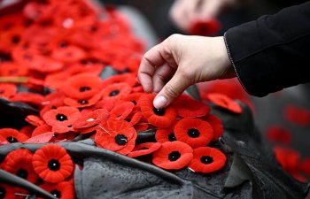 People place poppies on the Tomb of the Unknown Soldier after the Remembrance Day ceremony at the National War Memorial in Ottawa on Monday, Nov. 11, 2024. THE CANADIAN PRESS/Justin Tang