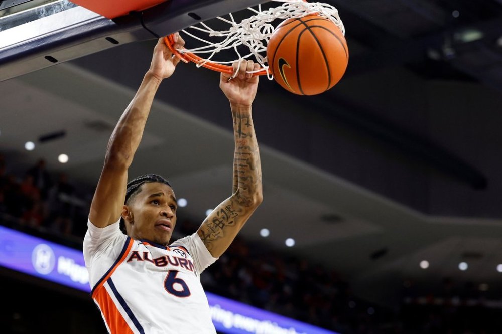 Auburn guard Elyjah Freeman slam dunks the ball during the second half of an NCAA college basketball game against NC State, Wednesday, Dec. 3, 2025, in Auburn, Ala. (AP Photo/Butch Dill)
