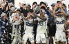 Vancouver Whitecaps midfielder Ryan Gauld (25) and Édier Ocampo (18) hold up the trophy after winning the MLS Western Conference final soccer match against San Diego FC, Saturday, Nov. 29, 2025, in San Diego. (AP Photo/Denis Poroy)