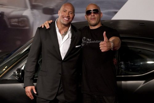 Actors Vin Diesel, right, and Dwayne Johnson pose for photos as they arrive to attend the premiere of the film Fast Five in Rio de Janeiro, Brazil, Friday April 15, 2011. (AP Photo/Felipe Dana)