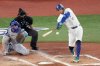 Toronto Blue Jays outfielder George Springer (4) singles during third inning Game 7 World Series playoff MLB baseball action against the Los Angeles Dodgers, in Toronto, Saturday, Nov. 1, 2025. THE CANADIAN PRESS/Chris Young