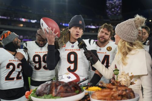 Cincinnati Bengals quarterback Joe Burrow (9) joined by safety Geno Stone (22), defensive end Myles Murphy (99) and center Ted Karras (64) talks with NBC Sports sideline reporter Melissa Stark, right, after NFL football game against the Baltimore Ravens, Thursday, Nov. 27, 2025, in Baltimore. (AP Photo/Stephanie Scarbrough)