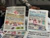 A vendor display local newspapers on the street of Lagos with headlines of the Government Girls Comprehensive Secondary School, where gunmen on Monday attacked the school dormitory, abducted schoolgirls, in Kebbi Nigeria, Wednesday, Nov. 19 2025. (AP Photo/Sunday Alamba )