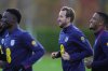 England's Harry Kane, right, during a training session in London, Wednesday, Nov. 12, 2025, ahead of the World Cup qualifying match against Serbia on Thursday. (AP Photo/Kirsty Wigglesworth)