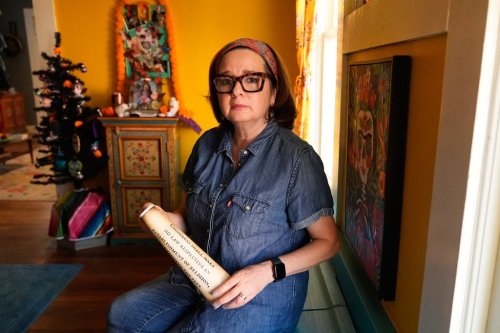 Gigi Cervantes, who resigned from her position as a theater teacher at a Fort Worth school rather than teach in a classroom where the Ten Commandments are hung, poses for a photo at her home, Wednesday, Nov. 5, 2025, in Fort Worth, Texas. (AP Photo/Tony Gutierrez)