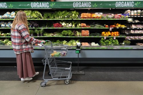A person shops for produce, at a grocery store in Baltimore, Monday, Nov. 10, 2025. (AP Photo/Stephanie Scarbrough)