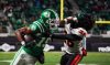 Saskatchewan Roughriders receiver Samuel Emilus (19) stiff arms B.C. Lions defensive back Robert Carter Jr. (26) during the second half of the CFL West Division final football action in Regina, on Saturday, November 8, 2025. THE CANADIAN PRESS/Heywood Yu