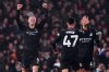 Manchester City's Erling Haaland, lef, celebrates after scoring the opening goal, the 100th goal in his Premier League career, during the English Premier League soccer match between Fulham and Manchester City in London, Tuesday, Dec. 2, 2025. (Bradley Collyer/PA via AP)