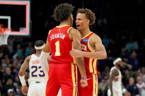 Atlanta Hawks forward Jalen Johnson (1) and Dyson Daniels, right, celebrate comeback win against Phoenix Suns during the second half of an NBA basketball game in Phoenix, Sunday, Nov. 16, 2025. Atlanta won 124-122. (AP Photo/Darryl Webb)