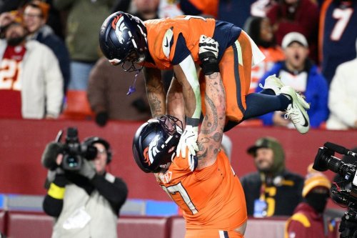 Denver Broncos running back RJ Harvey, is lifted by teammate Quinn Meinerz after scoring during overtime of an NFL football game against the Washington Commanders Sunday, Nov. 30, 2025, in Landover, Md. (AP Photo/Nick Wass)