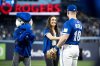 Jade Kovacevic, the first player signed to the Northern Super League (NSL) shakes the hand of Toronto Blue Jays outfielder Alan Roden (18) after throwing the ceremonial first pitch before an MLB baseball game between the Toronto Blue Jays and the Baltimore Orioles, in Toronto on Saturday, March 29, 2025. THE CANADIAN PRESS/Christopher Katsarov