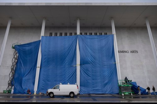 Tarps are installed in front of the sign on the Kennedy Center on Friday, Dec. 19, 2025, in Washington. (AP Photo/Mark Schiefelbein)