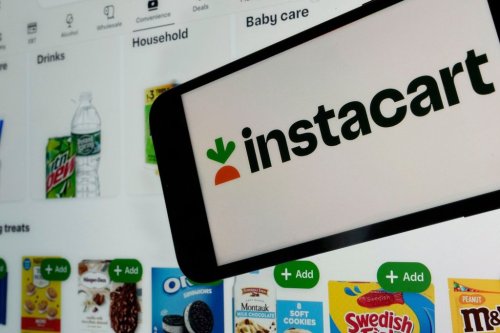FILE - An instacart logo and an instacart webpage are seen in New York, Sept. 6, 2023. (AP Photo/Richard Drew, File)