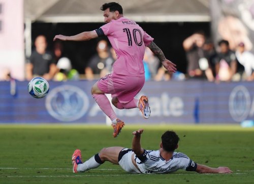 Inter Miami's Lionel Messi (10) leaps over Vancouver Whitecaps' Sebastian Berhalter (16) during the second half of the MLS Cup final soccer match, in Fort Lauderdale, Fla., on Saturday, Dec. 6, 2025. THE CANADIAN PRESS/Darryl Dyck