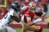 Tennessee Titans cornerback Marcus Harris (26) tackles San Francisco 49ers wide receiver Ricky Pearsall (1) after a catch during the first half of an NFL football game, Sunday, Dec. 14, 2025, in Santa Clara, Calif. (AP Photo/Jed Jacobsohn)