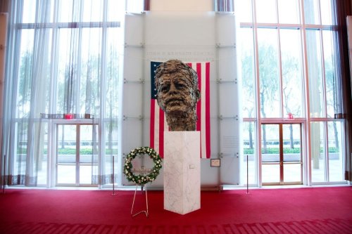 FILE - A memorial wreath stands next to the bronze memorial bust by Robert Berks of President John F. Kennedy in the grand foyer at the John F. Kennedy Center for the Performing Arts in Washington, Nov. 22, 2013, on the 50th anniversary of Kennedy's death. (AP Photo/Carolyn Kaster, File)