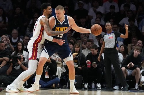 Miami Heat center Kel'El Ware, left, defends Denver Nuggets center Nikola Jokic (15) during the first half of an NBA basketball game, Monday, Dec. 29, 2025, in Miami. (AP Photo/Lynne Sladky)
