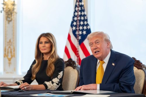 President Donald Trump, accompanied by first lady Melania Trump, speaks during a call with service members at his Mar-a-Lago club, Wednesday, Dec. 24, 2025, in Palm Beach, Fla. (AP Photo/Alex Brandon)
