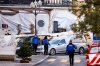 A hearse car drives as police officers inspect the area where a fire broke out at the Le Constellation bar and lounge during New Year's celebration, in Crans-Montana, Switzerland, Thursday, Jan. 1, 2026. (Jean-Christophe Bott/Keystone via AP)