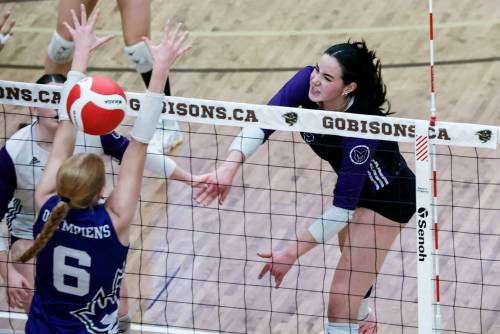 JOHN WOODS / WINNIPEG FREE PRESS
                                Vincent Massey’s Hannah McGregor (right) scores the winning point against the Jeanne-Sauvé Olympiens Monday in the varsity girls provincial volleyball championship.