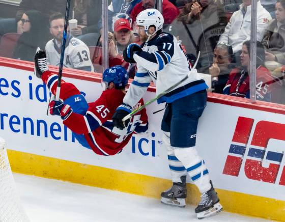 Jets captain Adam Lowry got the better of this encounter with the Habs’ Alexandre Carrier on Wednesday night in Montreal. (Christopher Katsarov / The Canadian Press files)