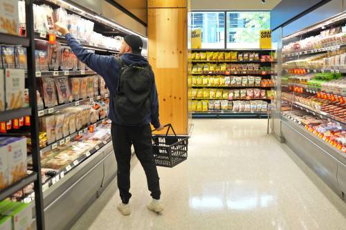 Chris Young / The Canadian Press
                                A shopper reaches for groceries.