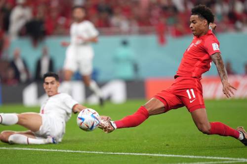 Nathan Denette / THE CANADIAN PRESS FILES
                                Canada forward Tajon Buchanan (left) tries to get his foot on a pass during the 2022 World Cup in Qatar. The former host country was drawn into Canada’s Group on Friday along with Switzerland and the winner of the UEFA playoff in March.