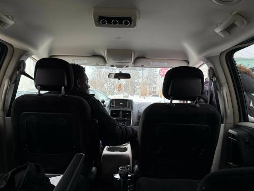 Inner City Youth Alive education outreach worker Sam Ayigbe picks up a high school student in the North End to drive her to class. He helps three students get to class that day.