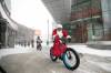 MIKAELA MACKENZIE / FREE PRESS
                                Event organizer Kerry LeBlanc leads the Cycle with Santa crew bike through downtown Winnipeg on Friday.