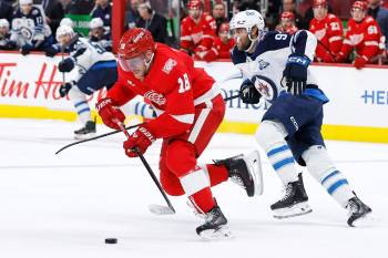 Detroit Red Wings centre Andrew Copp (18) is pursued up the ice by Winnipeg Jets centre Cole Perfetti (91) during the third period of Wednesday&rsquo;s game in Detroit. (Duane Burleson / The Associated Press)