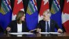 Prime Minister Mark Carney, right, signs an MOU with Alberta Premier Danielle Smith in Calgary,Thursday, Nov. 27, 2025. THE CANADIAN PRESS/Jeff McIntosh