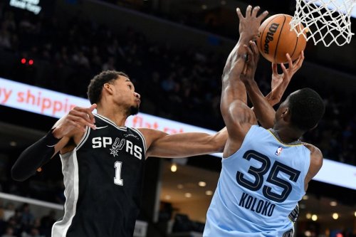 San Antonio Spurs forward Victor Wembanyama (1) and Memphis Grizzlies center Christian Koloko (35) reach for the ball in the first half of an NBA basketball game Tuesday, Jan. 6, 2026, in Memphis, Tenn. (AP Photo/Brandon Dill)
