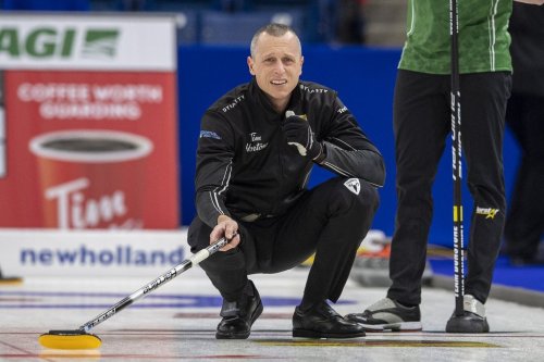 Team Jacobs second E.J. Harnden throws against Team Dunstone during Draw 4 of the 2021 Canadian Olympic curling trials in Saskatoon, Sask., Sunday, Nov. 21, 2021. THE CANADIAN PRESS/Liam Richards